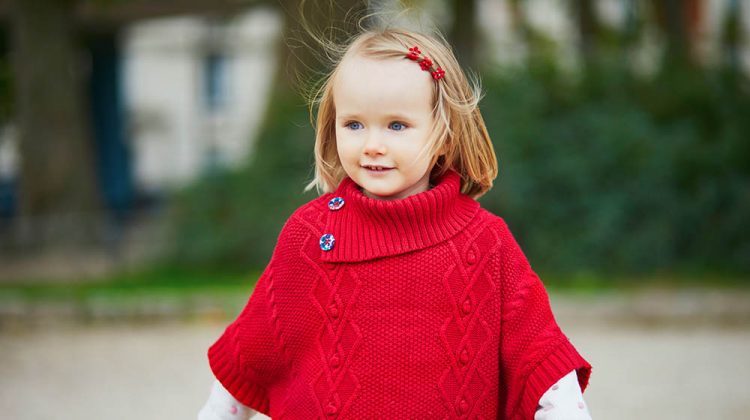 adorable toddler girl red poncho walking | Knitted Poncho Ideas To Make Your Kids Winter-Proof | Featured