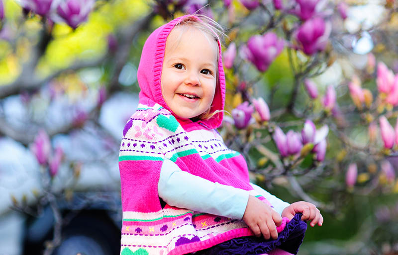outdoor portrait adorable happy little toddler | knitted poncho