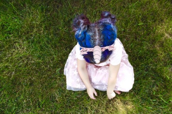 little girl with unicorn colored hair wearing unicorn headband and costume | DIY Halloween Costume Ideas