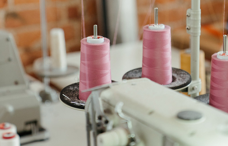 pink pillar candles on white metal rack | basic sewing skills