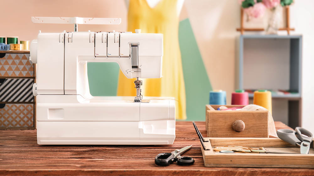 sewing machine on table tailors workshop | Dainty Sewing Table Ideas | Featured