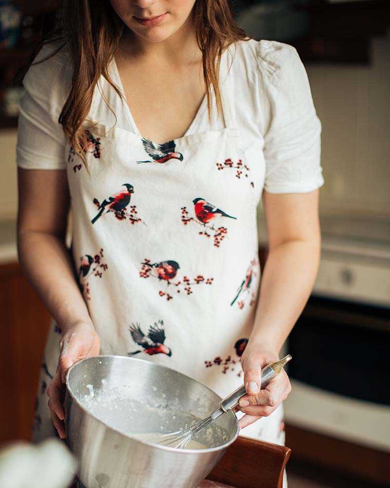 woman wearing apron holding stainless steel bowl | apron pattern