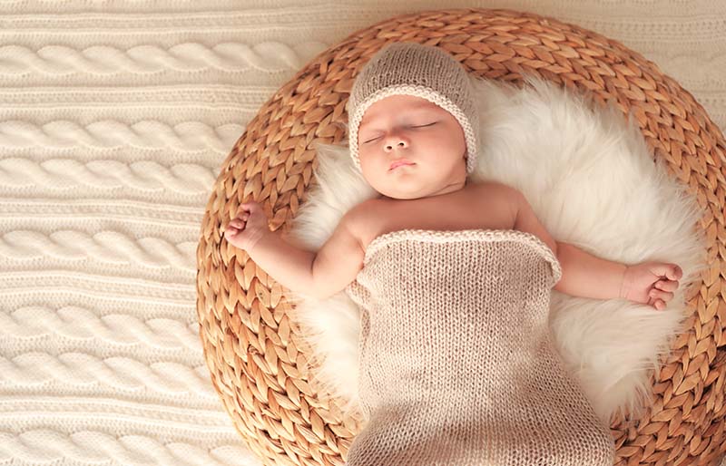 cute little baby sleeping on bed | winter clothes for newborn