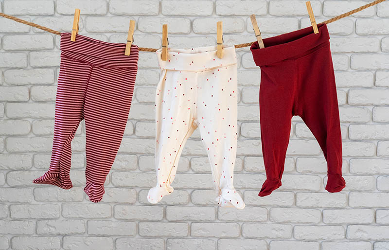 washing baby clothes pinned on rope | winter clothes for newborn