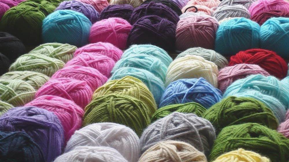 yarn wool rolls textiles colorful | Essential Crochet Tools For Beginners