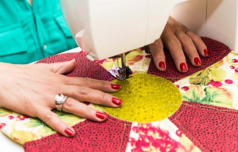 hands woman using sewing machine | sewing hacks