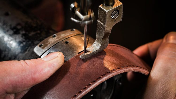 sewing process leather belt mans hands | What Is The Best Leather Sewing Machine For You | Featured