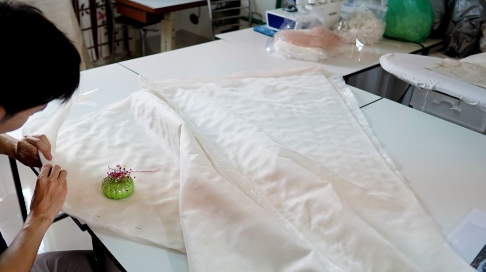 tailor cutting white silk fabric wedding | How To Sew Your Own Silk Pillowcase