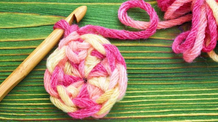 Warm pink winter yarn ball for knitting and crochet on the wooden table | How To Do A Magic Ring Crochet Perfectly | magic circle crochet | Featured