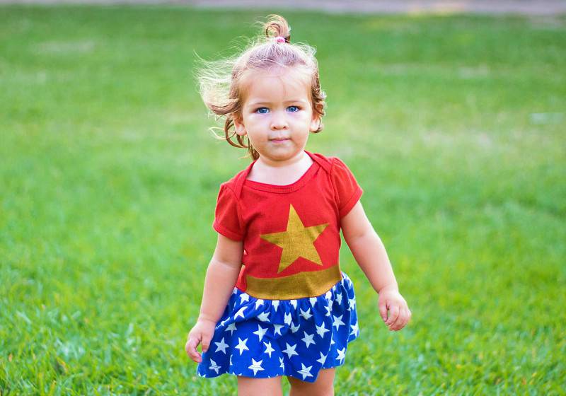 girl wearing wonder woman dress walking on green-grass field during daytime | baby halloween costume patterns