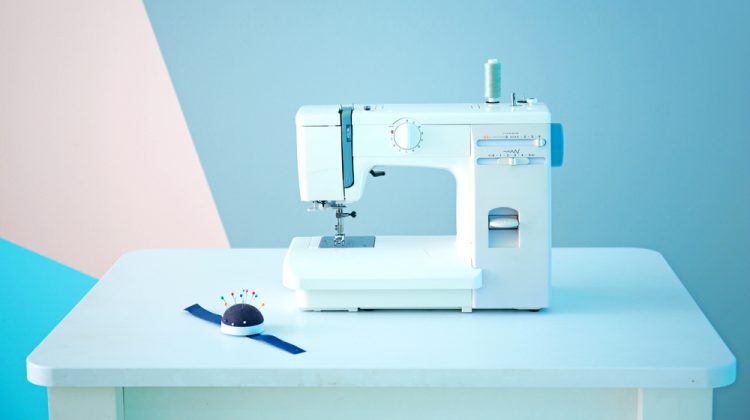 white sewing machine on the table with blue backdground | The Best Portable Sewing Machine | Top 10 Sewing Choices | Featured