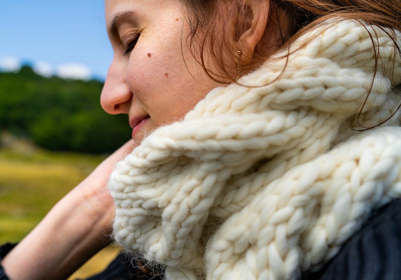 woman wearing white scarf smiling | ## Easy Infinity Scarf Crochet Ideas For The Cold Season | length of infinity scarf crochet