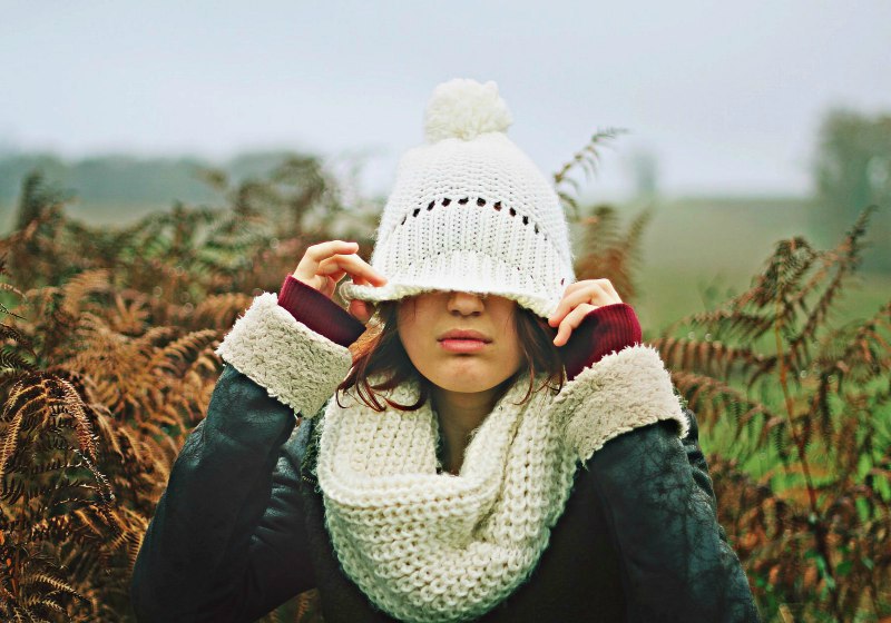 woman in white black sweater holding white knit cap photo | ## Easy Infinity Scarf Crochet Ideas For The Cold Season | infinity scarf crochet pattern bulky yarn