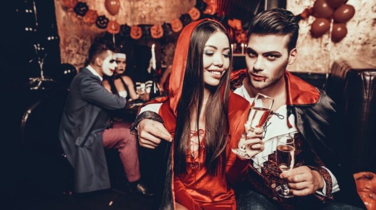 Young Couple Wearing Costumes Drinking Champagne | 13 DIY Couples Halloween Costumes: Why Buy When You Can Sew? | featured