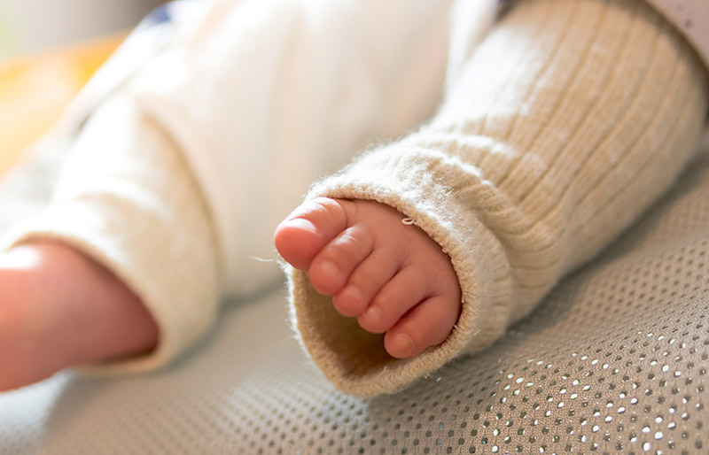 baby feet wearing neck warmers | winter clothes for newborn