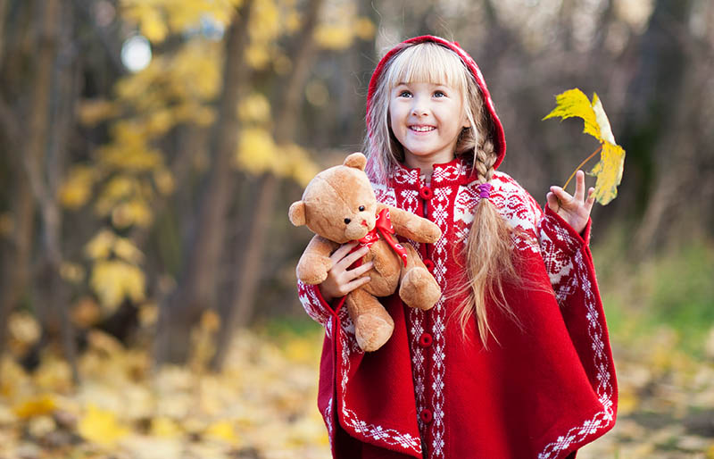 beautiful happy little girl teddy bear | knitted poncho