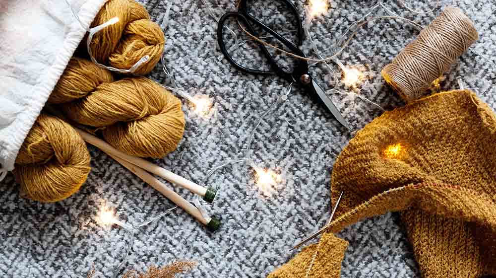 brown yarn on gray textile | Beginner Sewing Patterns You Can Do This Winter | Featured