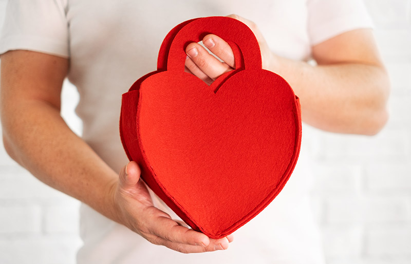 caucasian man white tshirt holding purse | valentines day sewing project ideas