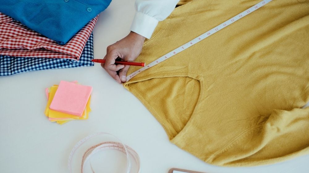 designer measuring long sleeve shirt | Great Clothes Alteration