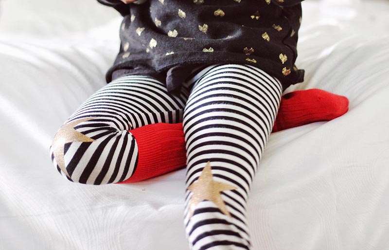 children holding gray game controller sitting on white bed | easy sewing projects for beginners