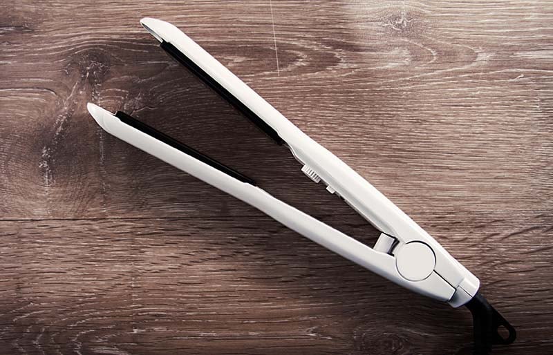 hair curling iron on wooden background | sewing hacks