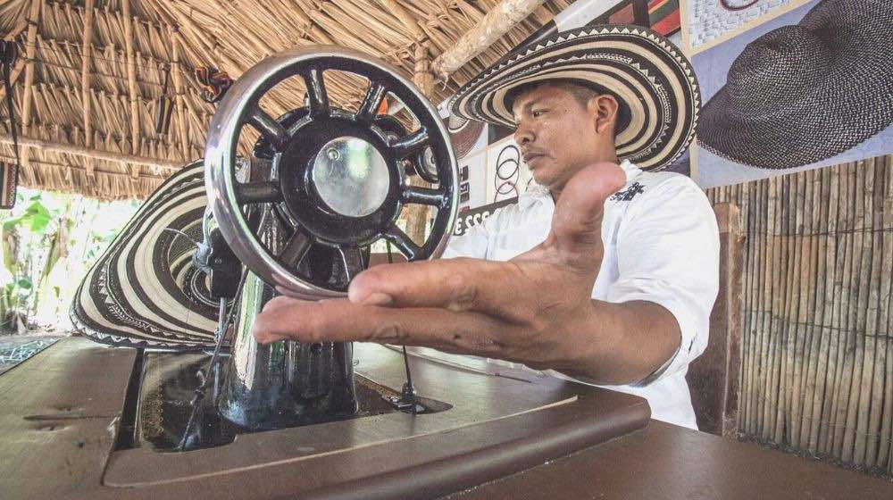 man sitting in front of sewing machien | Basic Sewing Machine Parts Every Beginner Should Know