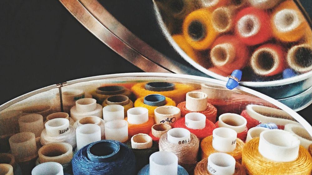multicolored spools thread round tin box | Easy DIY Sewing Box Perfect For Travelling