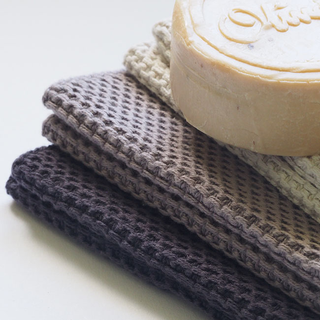 natural soap on towels on white background | Crochet Washcloth Patterns And Designs To Make Over The Weekend | how to crochet washcloth