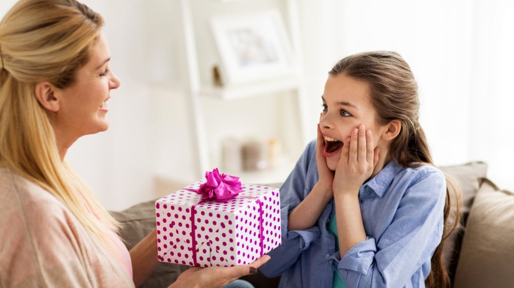 Happy girl receiving birthday present from mother at home | Easy Sewing Projects For Teens You Can Give As Gifts | simple sewing projects | Featured