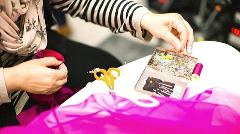 image of a woman seamstress busy sewing | How to Sew By Hand In 6 Easy Steps | how to sew