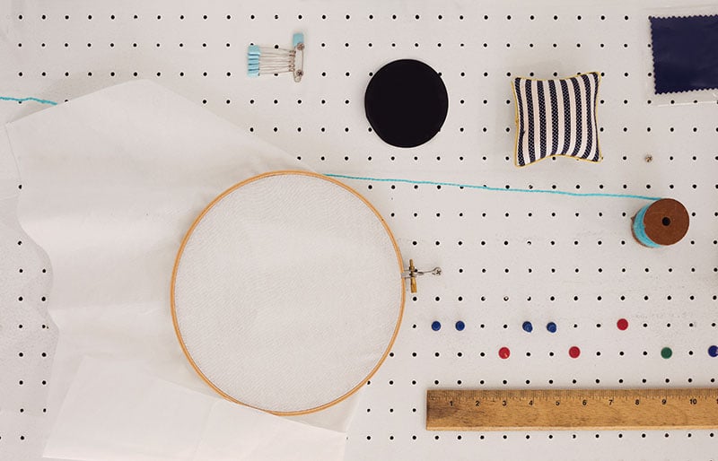 sewing equipment hanging on peg board | diy sewing room organization ideas