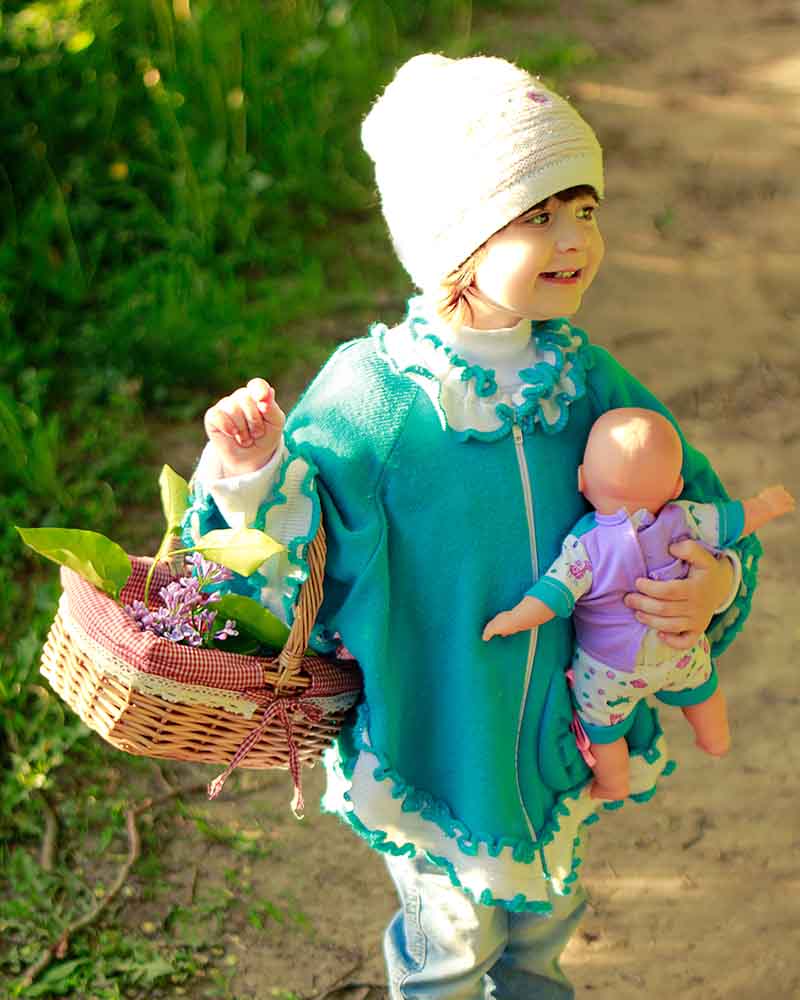 smiling beautiful girl white hat blue | knitted poncho