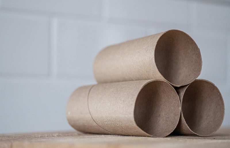 stack of carton rolls on table | diy sewing room organization ideas