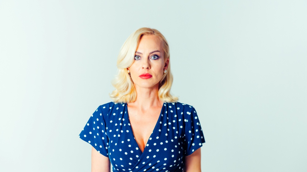 portrait of beautiful blonde woman in a dark blue dress | A 1950’s Spring Dress To Make And Wear This Season | spring dress | dress for spring | Featured