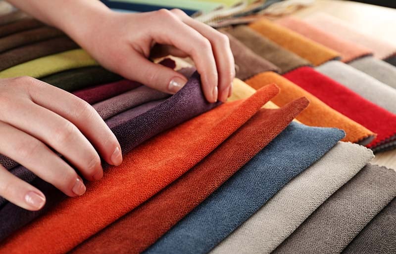 woman chooses scraps colored tissue | diy sewing room organization ideas
