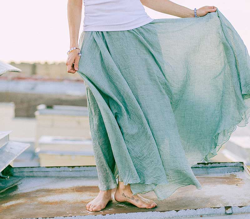woman in white and green dress standing on dock | easy sewing projects for beginners