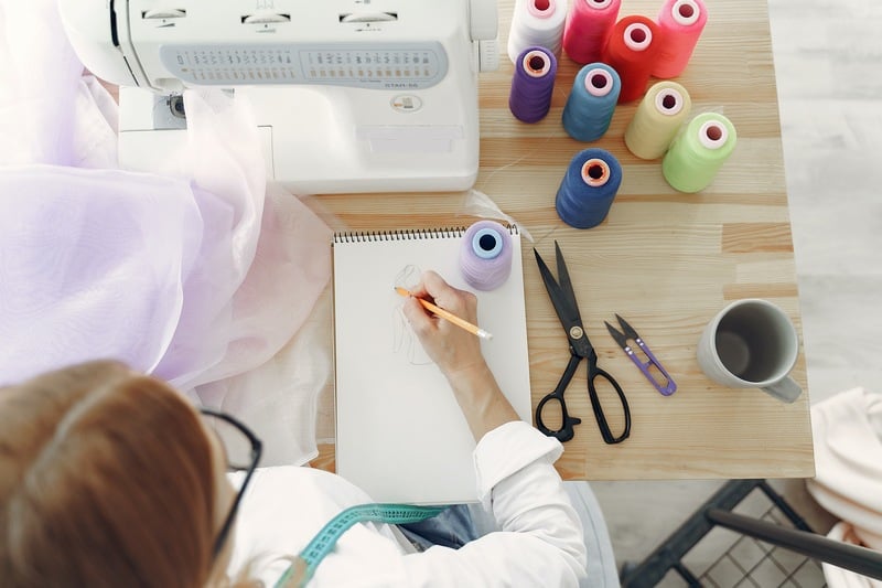 woman in white long sleeve shirt sketching | Sewing 101 | Most Important Sewing Terms You Need To Know Now | Sewing terms