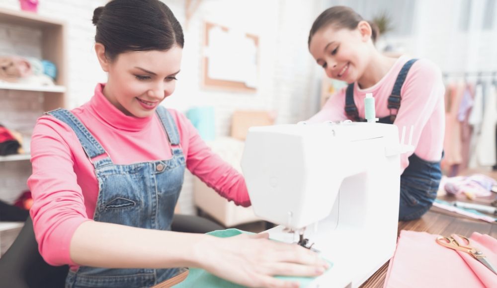 woman sews on sewing machine | Free Sewing Patterns You Can Make With Your Kids